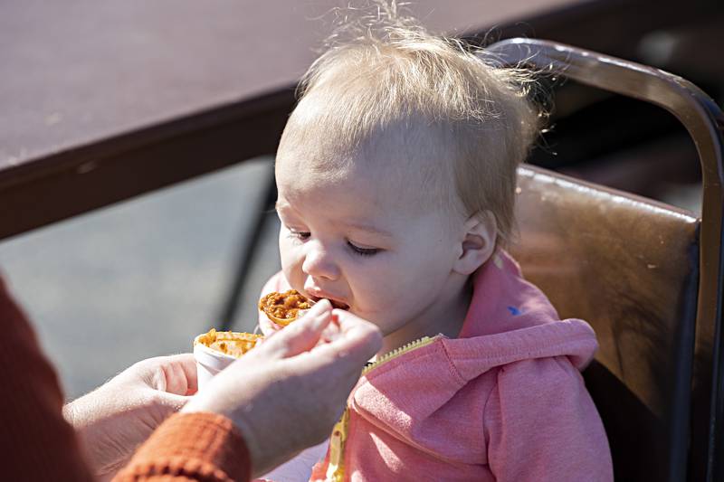 Reagan Stanley, 18 months, digs into some chili as fed to her from grandma Tiffany Marquez Sunday, Oct. 22, 2023 at the Elks Club in Dixon.