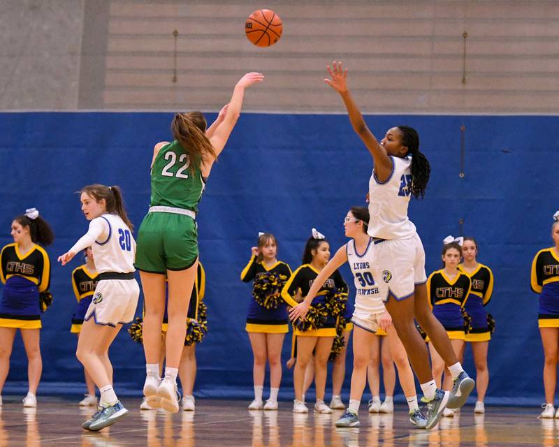 Lyons Township Nora Ezike,right,  tries to block the shot of York Stella Kohl (22) during the second quarter Friday Feb. 3rd held at Lyons Township High School.