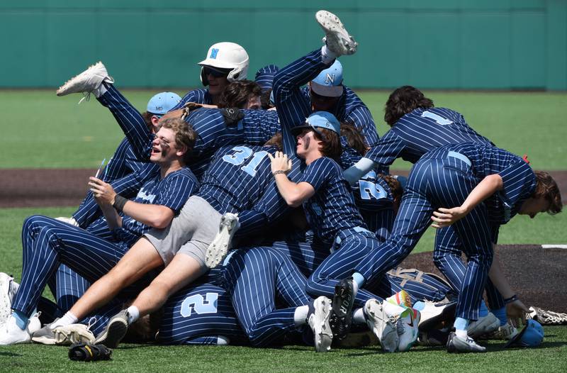 Joe Lewnard/jlewnard@dailyherald.com
Nazareth players celebratre their 7-2 victory over Grayslake Central during the Class 3A state championship baseball game in Joliet Saturday.