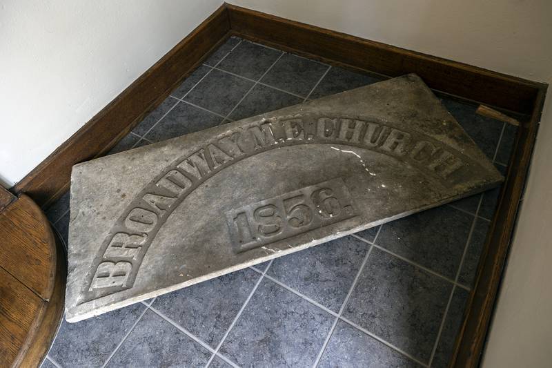 The original stone plaque for the church was put into storage in the bell tower many years ago. Needing the help of some young men, the stone was finally retrieved from the cramped space.