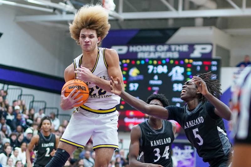 Yorkville Christian's Noah Aguado (22) pulls down a rebound against Kanelan during a championship final basketball game in the 61st annual Plano Christmas Classic at Plano High School on Saturday, December 28, 2024.