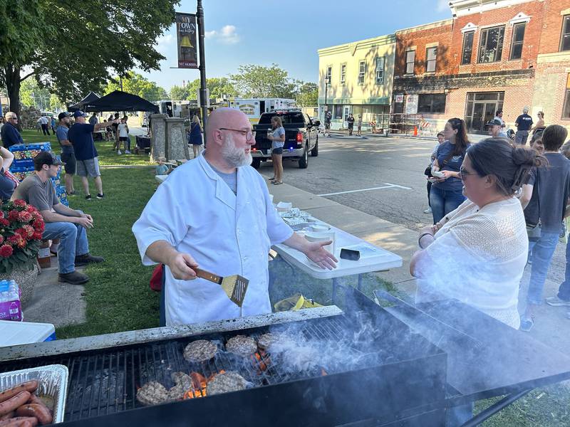 Brandon Lands, men's group leader for the Riverstone Church in Oregon, was busy grilling burgers and hot dogs at the National Night Out event in Mt. Morris on Tuesday, Aug. 5, 2025 in Mt. Morris. The event was organized by the Mt. Morris Police Department.