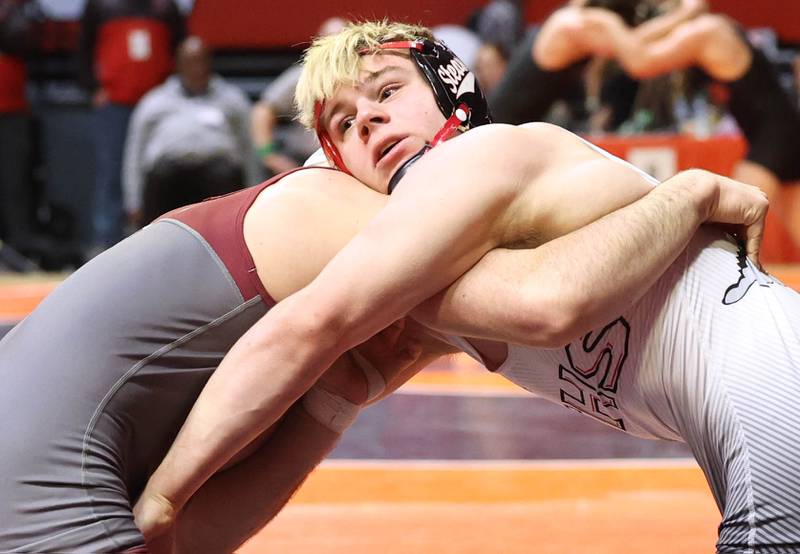 Fulton’s Zane Pannell and Unity’s Kyus Root wrap up in the Class 1A 170 pound 3rd place match Saturday, Feb. 18, 2023, in the IHSA individual state wrestling finals in the State Farm Center at the University of Illinois in Champaign.