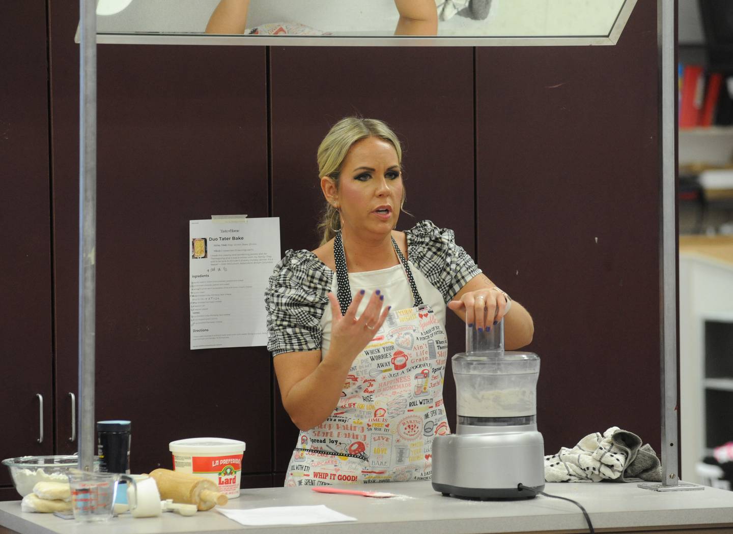 Teacher Suzanne Johnson show students how to make pie crust Tuesday April 19, 2022, during a foods class at Richmond-Burton High School. She works in the bake shop and coaches.
