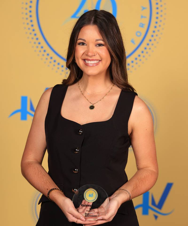 Kelsey Vogel poses with her 40 Under Forty award during the Illinois Valley Chamber of Commerce Champions of Change Awards Night on Thursday, April 10, 2025 at the Westclox Event Center in Peru.