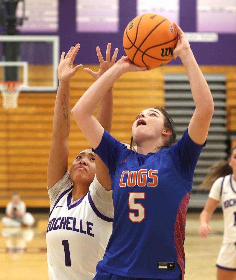 Genoa-Kingston's Zoe Boylen shoots in front of Rochelle's Carmela Bright during their game Monday, Dec. 15, 2025, at Rochelle High School.
