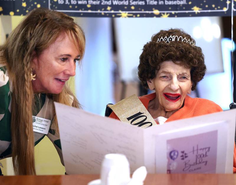 Claire Hubele, (right) a resident at Heritage Woods of DeKalb, reads a birthday card signed by other residents of the facility with Executive Director Rachel Lawson Wednesday, July 9, 2025, during a party celebrating her 100th birthday.