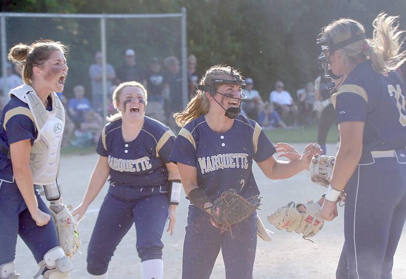 Members of the Marquette softball team (from left) Eva McCallum, Addie McConnaughhay, Lindsey Kaufmann, Paige Cottingim react after defeating Newark to win the Class 1A sectional game at Newark on Thursday June 10, 2021.