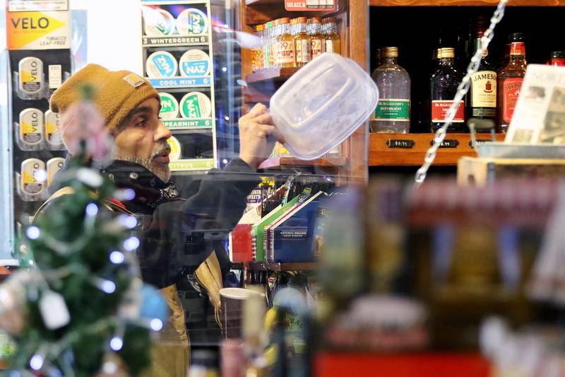 Creekside Country Store co-owner Karni Kahlon helps stock the store with clerk Pam Donzelli on Wednesday, Dec. 16, 2020, in Wonder Lake.