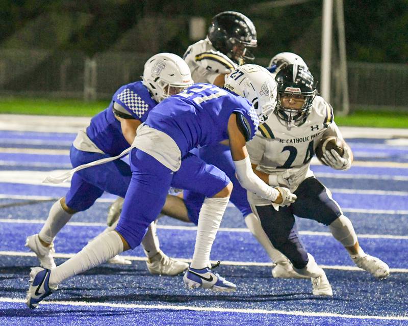 IC Catholic Prep David Velez (24) gains some yards before being brought down by St. Francis Isaac Saldana (27) in the second quarter on Friday Sep. 29, 2023, held at St. Francis in Wheaton.
