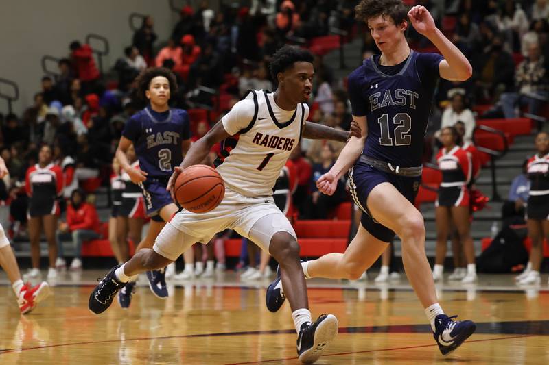 Bolingbrook’s Mekhi Cooper (1) drives to the basket against Oswego East on Wednesday, Jan. 11, 2023.