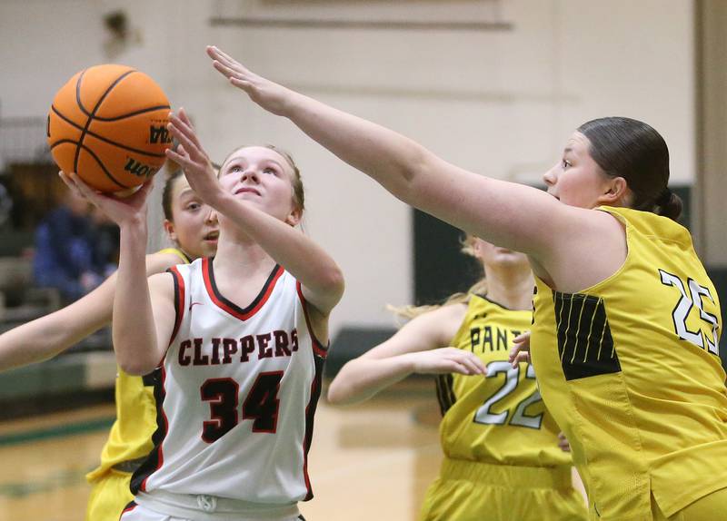 Amboy/Ohio's Bella Yanos eyes the hoop while running in the lane past Putnam County's Teachan Sarver during the Class 1A Regional semifinal game on Tuesday, Feb. 18, 2025 at St. Bede Academy.