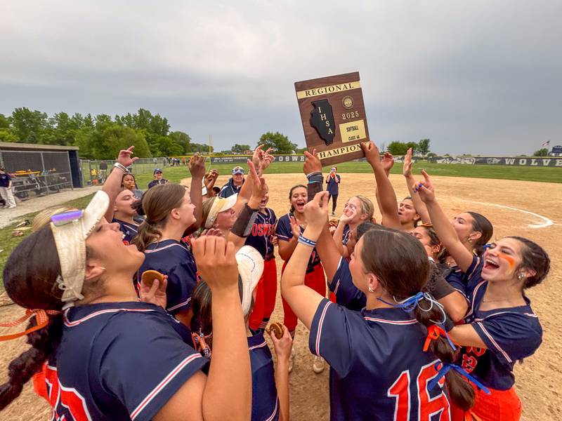 Oswego players raise the Regional Final Championship plaque in celebration after defeating Neuqua Valley in a Class 4A Oswego East Regional Final softball game at Oswego East High School on Friday, May 30, 2025.