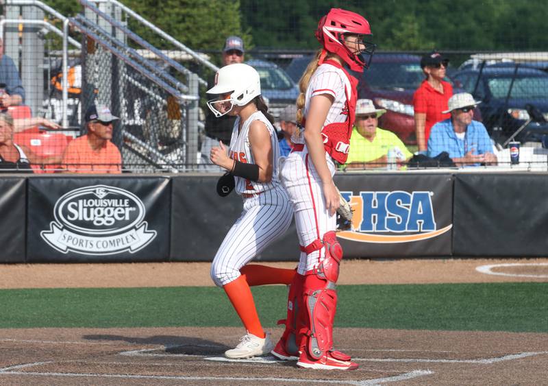 Oswego's Rhiana Martinez scores the teams second run as Barrington catcher Reese Cullen watches the play during the Class 4A championship game on Saturday, June 14, 2025 at the Louisville Slugger Sports Complex in Peoria.