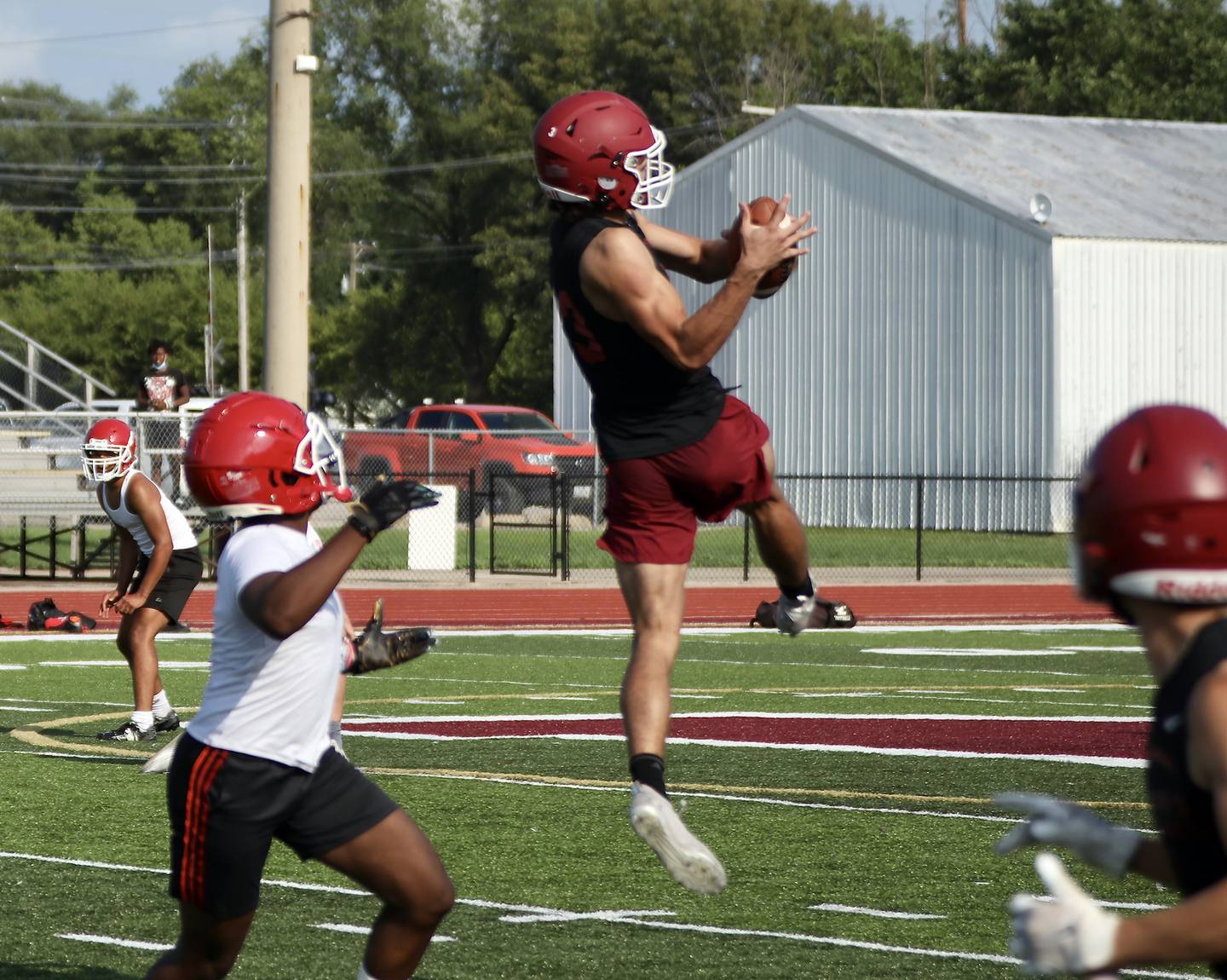 Morris' Sam Reddinger leaps high to intercept a pass Tuesday during a 7-on-7 competition against Yorkville.