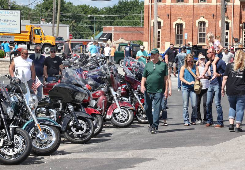 Visitors check out some of the motorcycles during the Fizz Ehrler Memorial Turning Back Time Car Show Sunday, July 30, 2023, in downtown Sycamore.