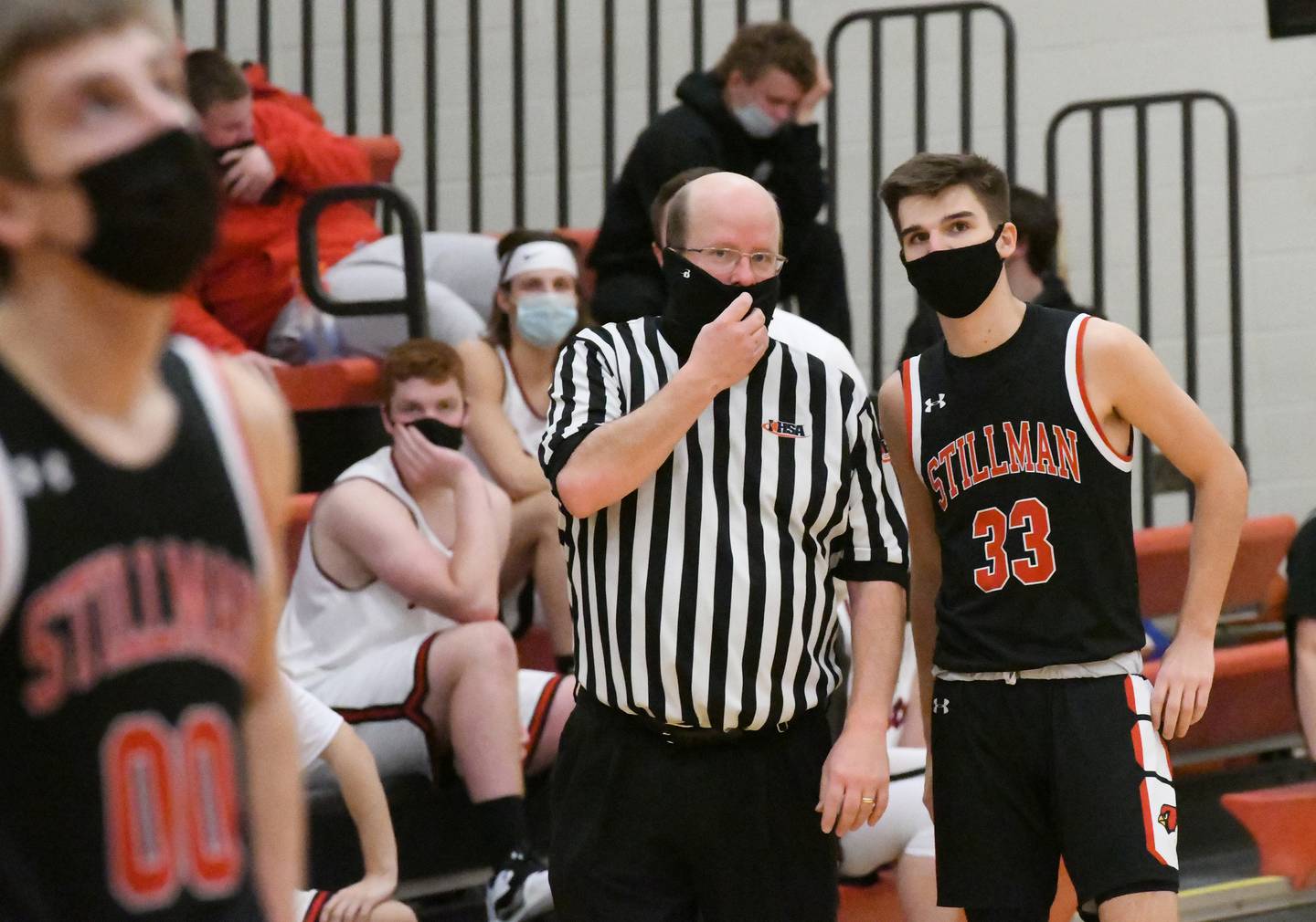 Basketball officials must wear masks when officiating games. Here, an official chats with Stillman Valley's David Wilhite during a game with Forreston.