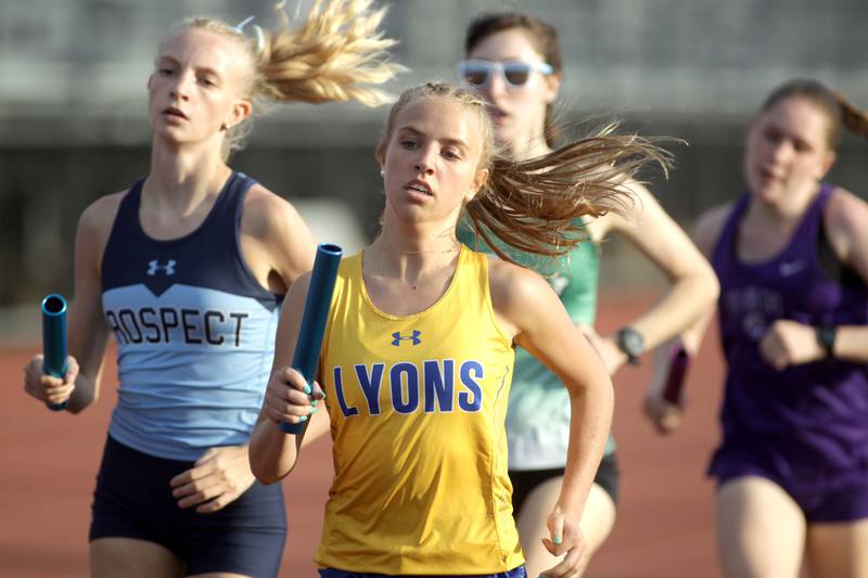 Lyons Township’s Catherine Sommerfeld runs the first leg of the 4x800-meter relay during the Ritter Invite girls track and field meet at Downers Grove North on Friday, April 14, 2023.