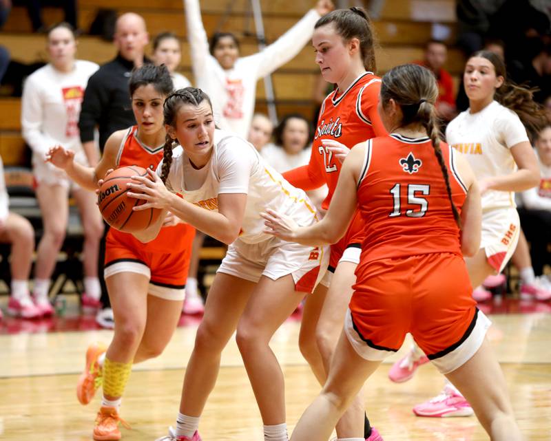 Batavia’s Brooke Carlson battles the St. Charles East defense during a game at Batavia on Thursday, Feb. 1, 2024.