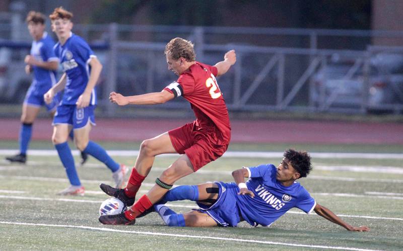 Batavia’s Alexander Marshall is tripped up by Geneva’s Nick Plata during a Tri-Cities Night game at St. Charles North High School on Thursday, Sept. 21, 2023.