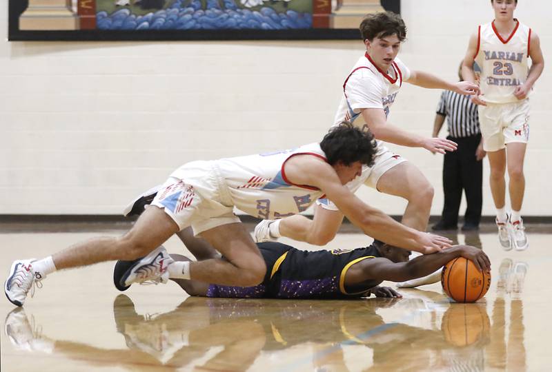 Marian Central's Adam Wrzos and his teammate, Logan Brandt, trry to get to a loose ball as Chicago Christian's Kerry Teague reaches for it during a Chicagoland Christian Conference basketball game on Tuesday, Jan. 21, 2025, at Marian Central High School.