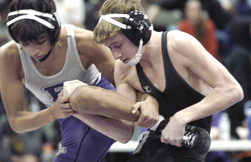 Dixon's Jack Ragan ties up Rochelle's Freddie Hernandez in the 113-pound championship bout at the Class 2A Dixon Regional on Saturday, Feb. 8, 2025 at Lancaster Gym in Dixon.
