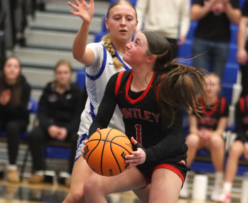 Huntley’s Lana Hobday, front, works past Burlington Central’s Ashley Waslo in varsity girls basketball on Monday, Feb. 9, 2026, at Central High School in Burlington.