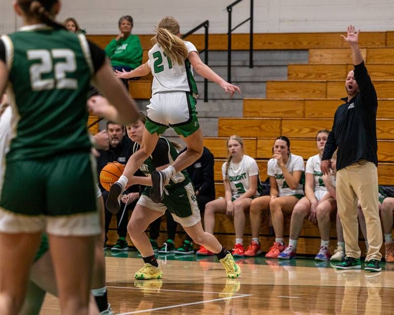 Ashlan Heersink (40) of St. Bede maneuvers ball away from a leaping Addy Sulzberger (21) of Dwight as their Head Coach Max Sulzberger yells a new defensive set for his team on sideline on Monday, January 19, 2026 at the Krese Memorial Gymnasium in Dwight.