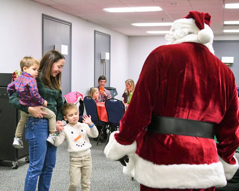 Christina Lynch along with Caden Lynch, 2, and Alexander Lynch, 4, say hello to Santa during the breakfast with Santa event on Sunday Dec. 15, 2024, held at the La Grange Park District Recreation Center.
