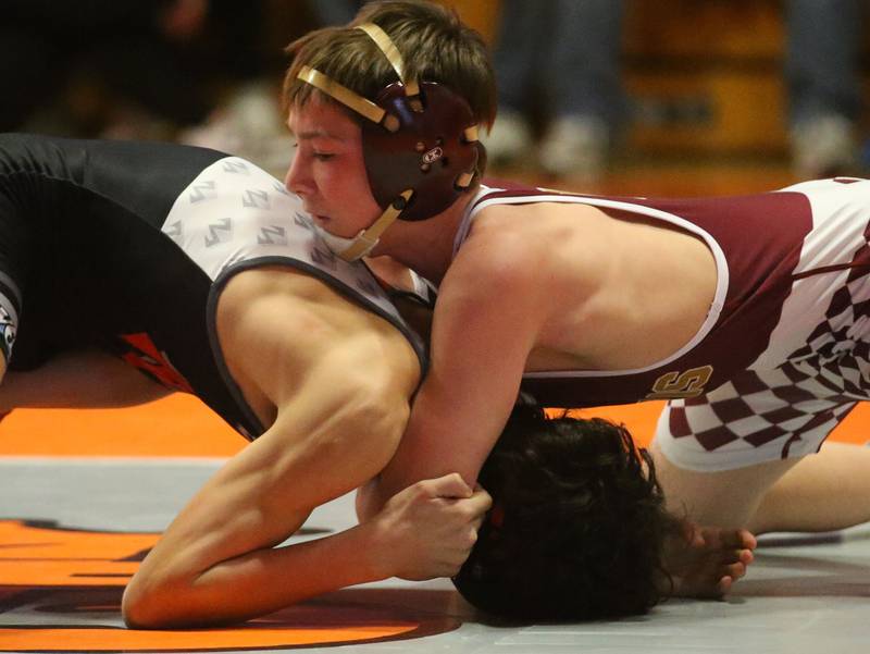 Morris's Paxton Valentine wrestles Morton's Noah Harris in the 113 weight class during the Class 2A Sectional championship on Saturday, Feb. 15, 2025 at Washington High School.