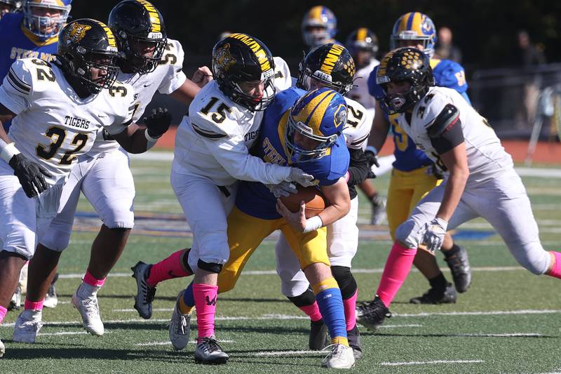 Joliet West’s Carl Bartolo sacks Joliet Central’s John Stasiak on Saturday.