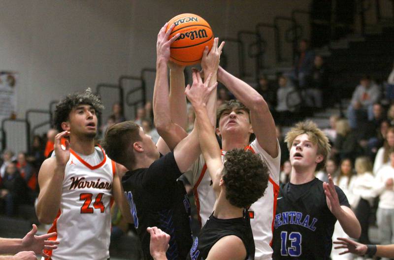 McHenry’s Blake Renfro, center, battles Burlington Central’s Declan Wilson for a rebound in varsity boys basketball on Friday, Dec. 5, 2025, at McHenry Community High School in McHenry.
