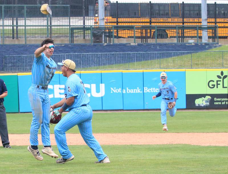 Marquette's Alec Novotney flings his cap in the air as teammates Sam Mitre and Caden Durdan celebrate after defeating Atlamont to win the Class 1A State championship title on Saturday, June 1, 2024 at Dozer Park in Peoria.