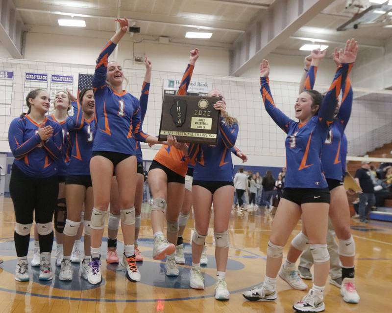 Members of the Genoa-Kingston celebrate defeating Quincy Notre Dame in three sets in the Class 2A Supersectional volleyball game on Friday, Nov. 4, 2022 at Princeton High School.