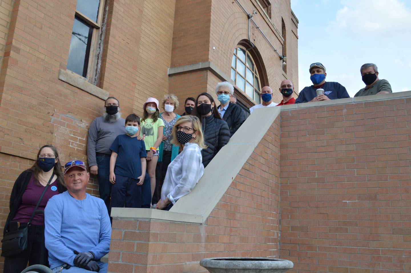 Protesters, including Adam Metz, front, who ran for village president in this month's election and lost, gathered on Richmond's Memorial Hall the evening of Tuesday, April 27, 2021, to protest the sale of the structure to a private entity.