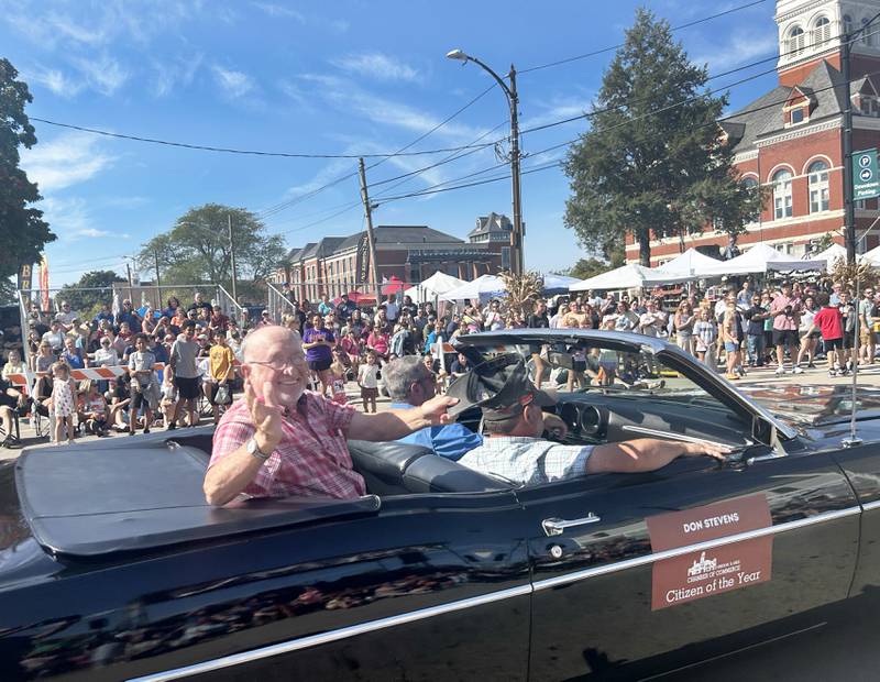 Don Stevens, the Oregon Chamber of Commerce's Citizen of the Year, waves to the crowd as he rides in the Harvest Time Parade held during the Autumn on Parade festival on Sunday, Oct. 5, 2025 in downtown Oregon.