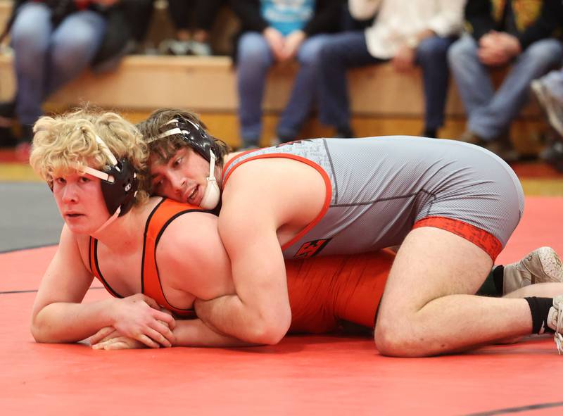 Yorkville's Hunter Janeczko, in grey, goes up against against Minooka's Hunter Coons during the Southwest Prairie Conference wrestling meet at Yorkville High School on Saturday, Jan. 21, 2023.