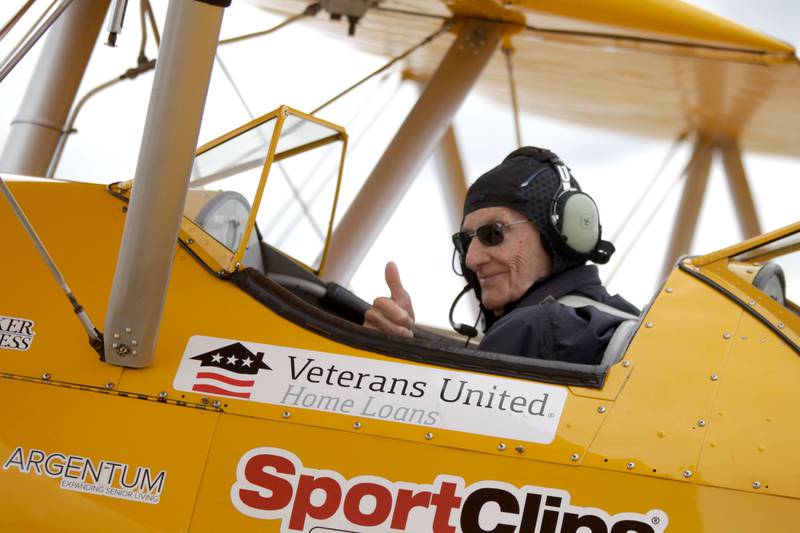 Guy Prisco, 93, a resident of Covenant Living at the Holmstad in Batavia, gives a “thumbs up” sign as he prepares to take off for a Dream Flight at the DuPage Airport in West Chicago on Saturday, July 29, 2023. The plane is a 1942 open cockpit Boeing Stearman, the same airplane used to train military aviators in the 1940s. The flights were courtesy of Ageless Aviation Dreams Foundation, a non-profit organization to honor U.S. military veterans living in long-term care facilities. Prisco was a First Lieutenant with the Army Corps of Engineers in the 1950s.