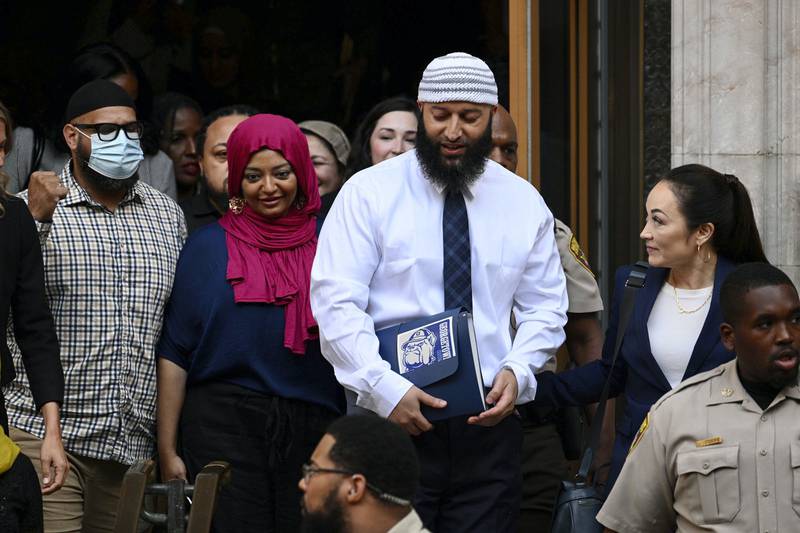 Adnan Syed, center right, leaves the courthouse after the hearing on Monday, Sept. 19, 2022, in Baltimore. A Baltimore judge ordered the release of  Syed after overturning his conviction for the 1999 murder of high school student Hae Min Lee — a case that was chronicled in the hit podcast “Serial,” a true-crime series that transfixed listeners and revolutionized the genre.  (Jerry Jackson/The Baltimore Sun via AP)
