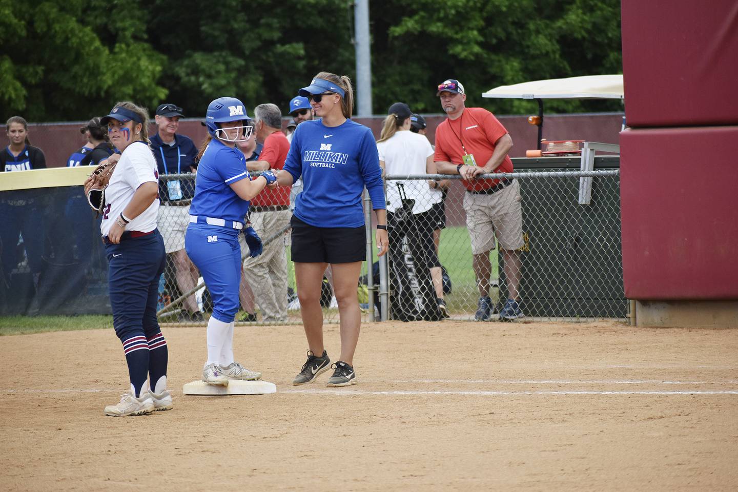 Millikin softball coach Katie Tenboer talks to a baserunner during a game at the NCAA Division III World Series. Tenboer, a Morrison native, led the Big Blue to the D-III championships for the first time in program history.