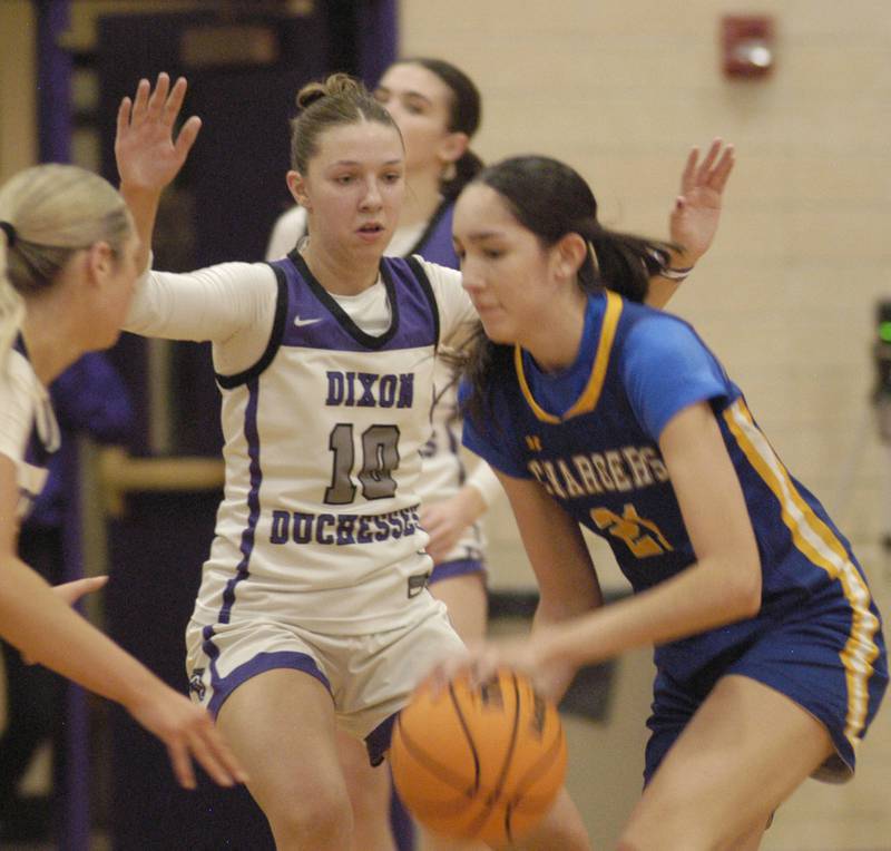 Dixon's Addy Lohse applies defensive pressure against Aurora Central Catholic's Sofia Orozco.  The Dixon Duchesses played  the Aurora Central Catholic Chargers in the Dixon Holiday Tournament
at Dixon High School on Friday, December 26th, 2025