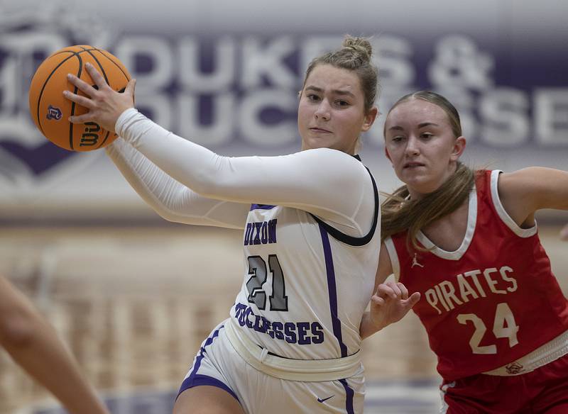 Dixon’s Reese Dambman drives to the lane against Ottawa’s Ashlynn Ganiere Wednesday, Dec. 4, 2024, at Dixon High School.