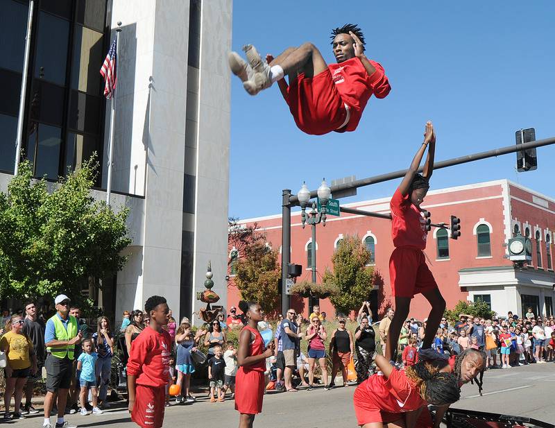 The Jesse White Tumblers stop and perform on LaSalle St in Ottawa Sunday during the Fall Fest Parade.