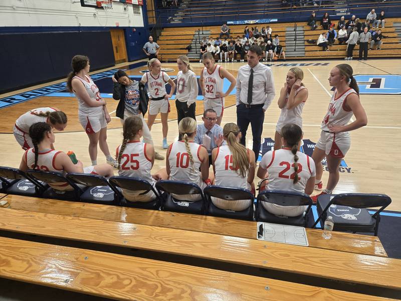Ottawa girls basketball coach Brent Moore (center) talks with his team during a time in the third quarter of the Pirates' 55-37 pool play victory over East Peoria on Thursday in the Bank of Pontiac Turkey Tip-Off Tournament at Prairie Central High School in Fairbury.