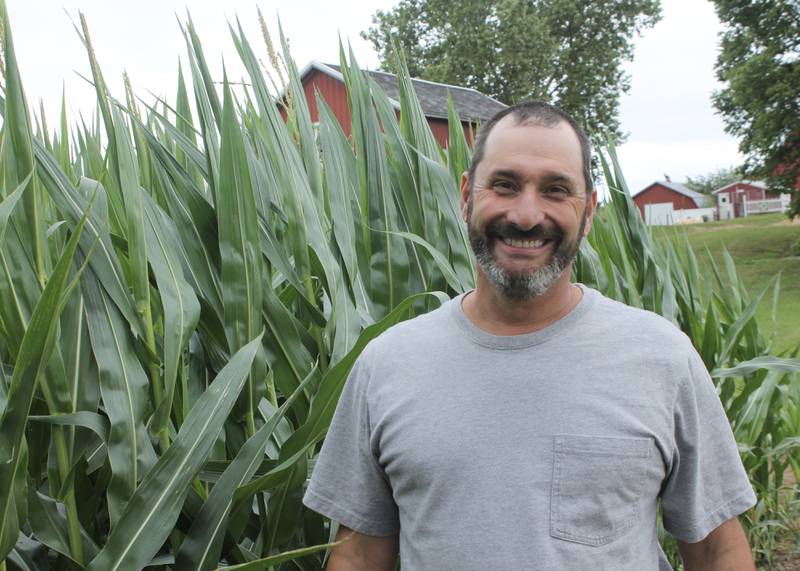 Keith Poole, a corn grower and hog farmer, stands next to corn that is beginning to tassel on Thursday, July 8, 2021, on his farm in rural Polo. Poole says this is a crucial time for the maturation of the crop. Ogle County is in drought conditions, although Poole said his farm received about half an inch of rain the day before.