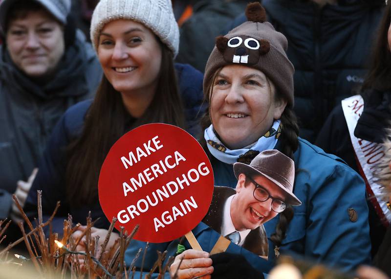 Lynn Richason, of St. Paul, Minnesota, watches on Sunday, Feb. 2, 2025, as Woodstock Willie links to see if he can see his shadow during the annual Groundhog Day Prognostication in the Woodstock Square.