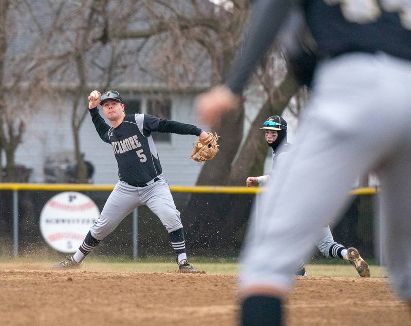 Sycamore's Ethan Steele (5) fields a grounder and throws to first for an out against Plano during a baseball game at Plano High School on Monday, April 4, 2022.