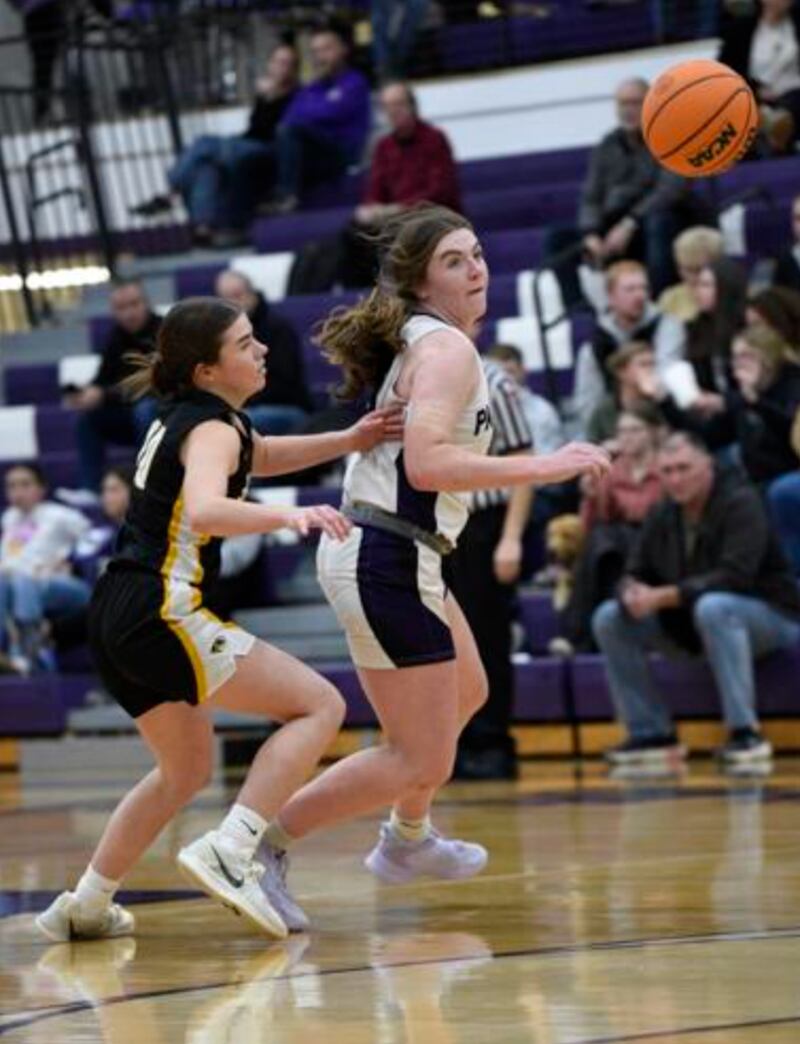 Manteno's Emily Horath, right, swipes the ball from Herscher's Rylan Adams, left, during Thursday's game in Manteno.