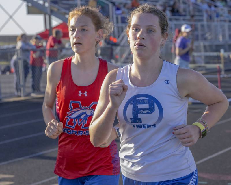 Princeton High School's Natalie Meyer battles to maintain her position against Morrison's Emma Christin during the girls 3200 meters varsity final at Mendota High School on May 3, 2024.