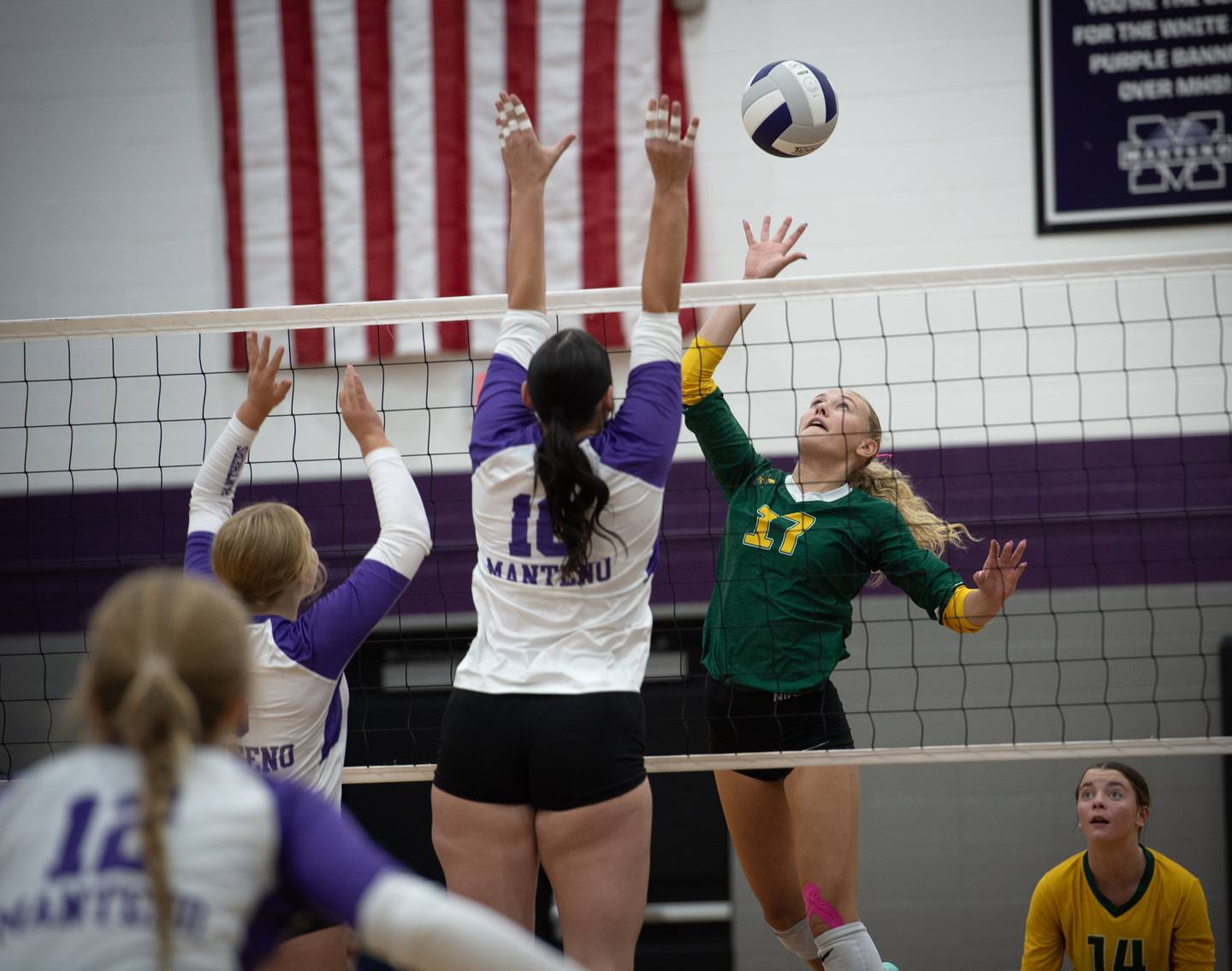 Coal City's Maggie Carlson, right, looks to tip the ball past Manteno's Kendall Blanchette, left, and Maddie Gesky, center, in a match on Thursday, September 11, 2025.